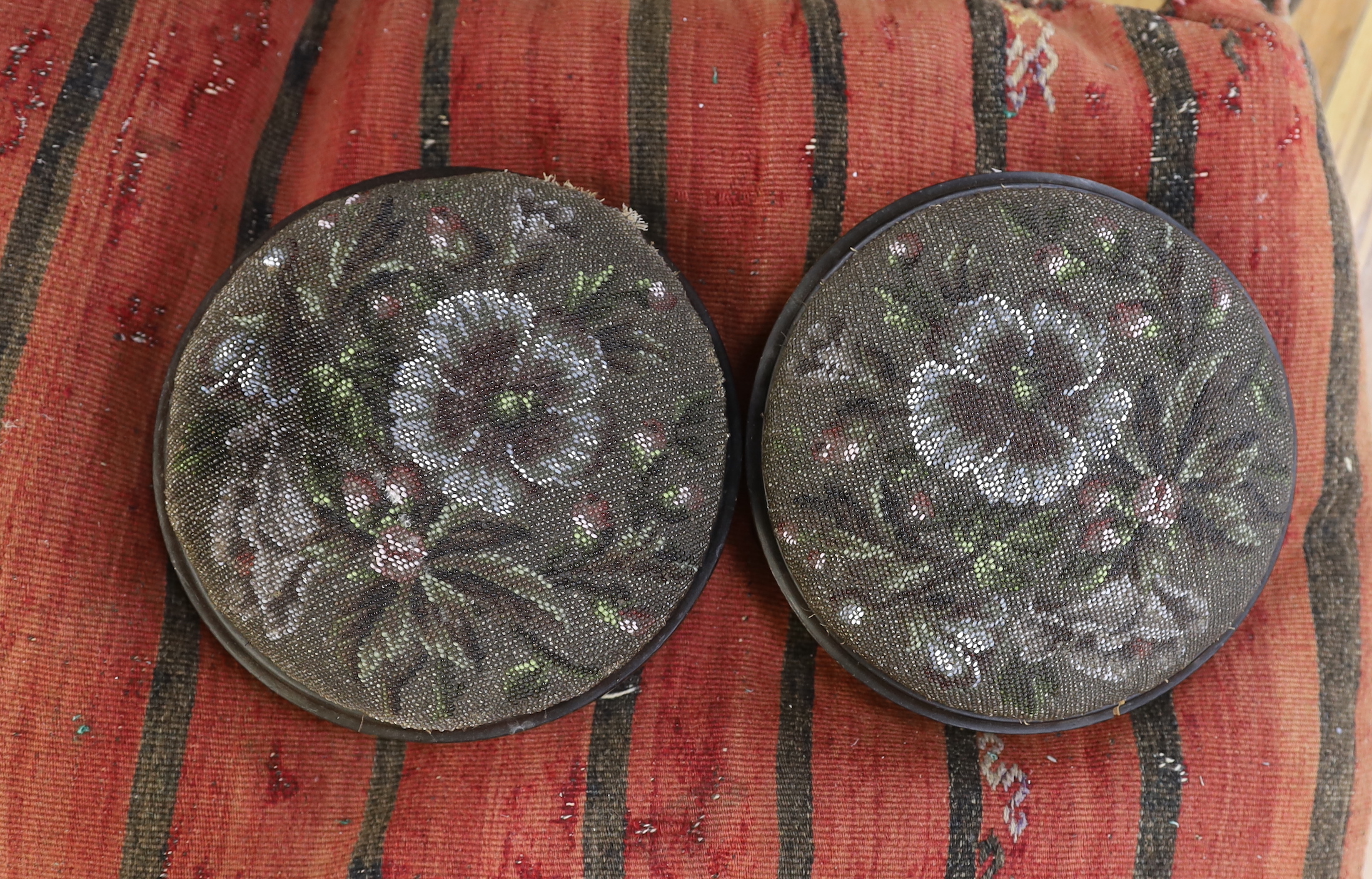 Two floral beadwork foot stools and a large Kilim cushion, the largest 75cm x 55cm